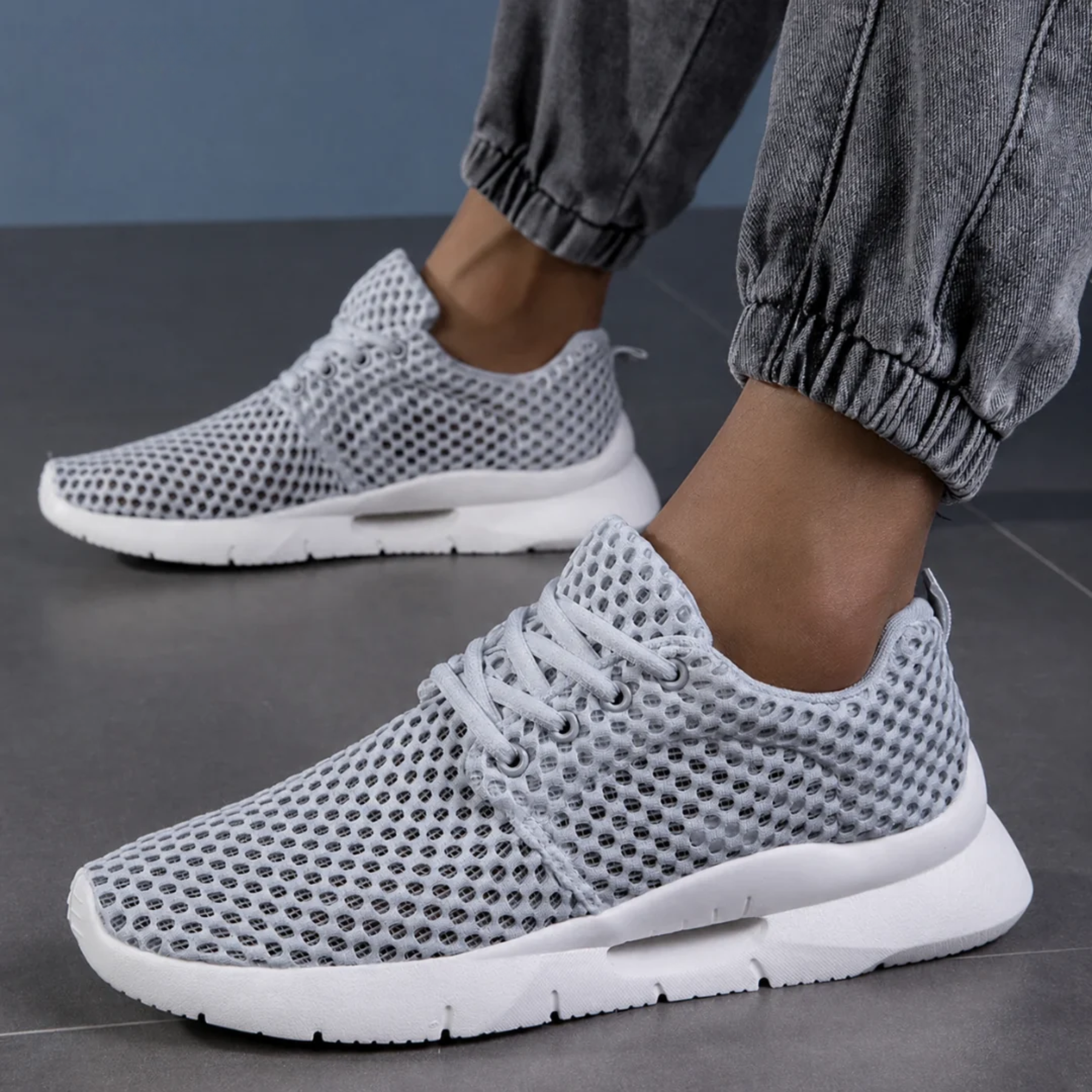 Zapatillas ortopédicas de malla en gris llevadas puestas, vista en ángulo