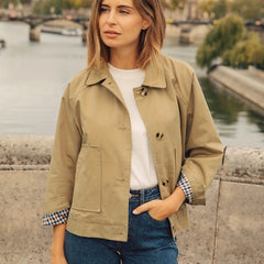 Mujer de frente con la chaqueta corta Olalla en caqui, abierta sobre camiseta blanca y vaqueros