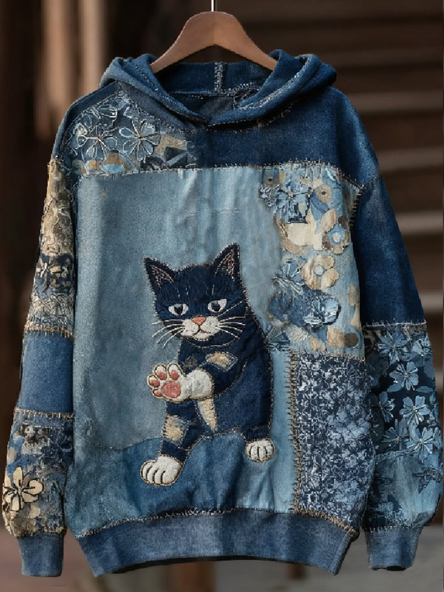 Sudadera vaquera con gato asomado al bolsillo